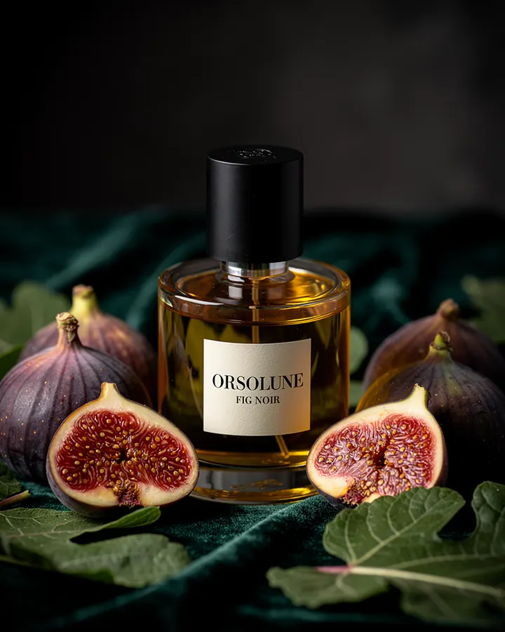 AI output for the third prompt: a round bottle with a black cap and a cream label reading Orsolune Fig Noir, filled with dark amber liquid, among halved figs on green velvet, with no headline or price.