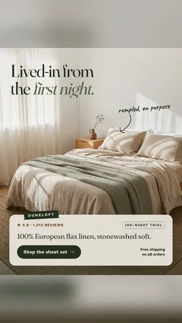 Soft cream Duneloft ad: 'Lived-in from the first night.' over a sunlit bed with rumpled oat linen sheets and a green waffle blanket, a handwritten note 'rumpled, on purpose', 4.8 from 1,513 reviews, and a 'Shop the sheet set' button. The 9:16 version.