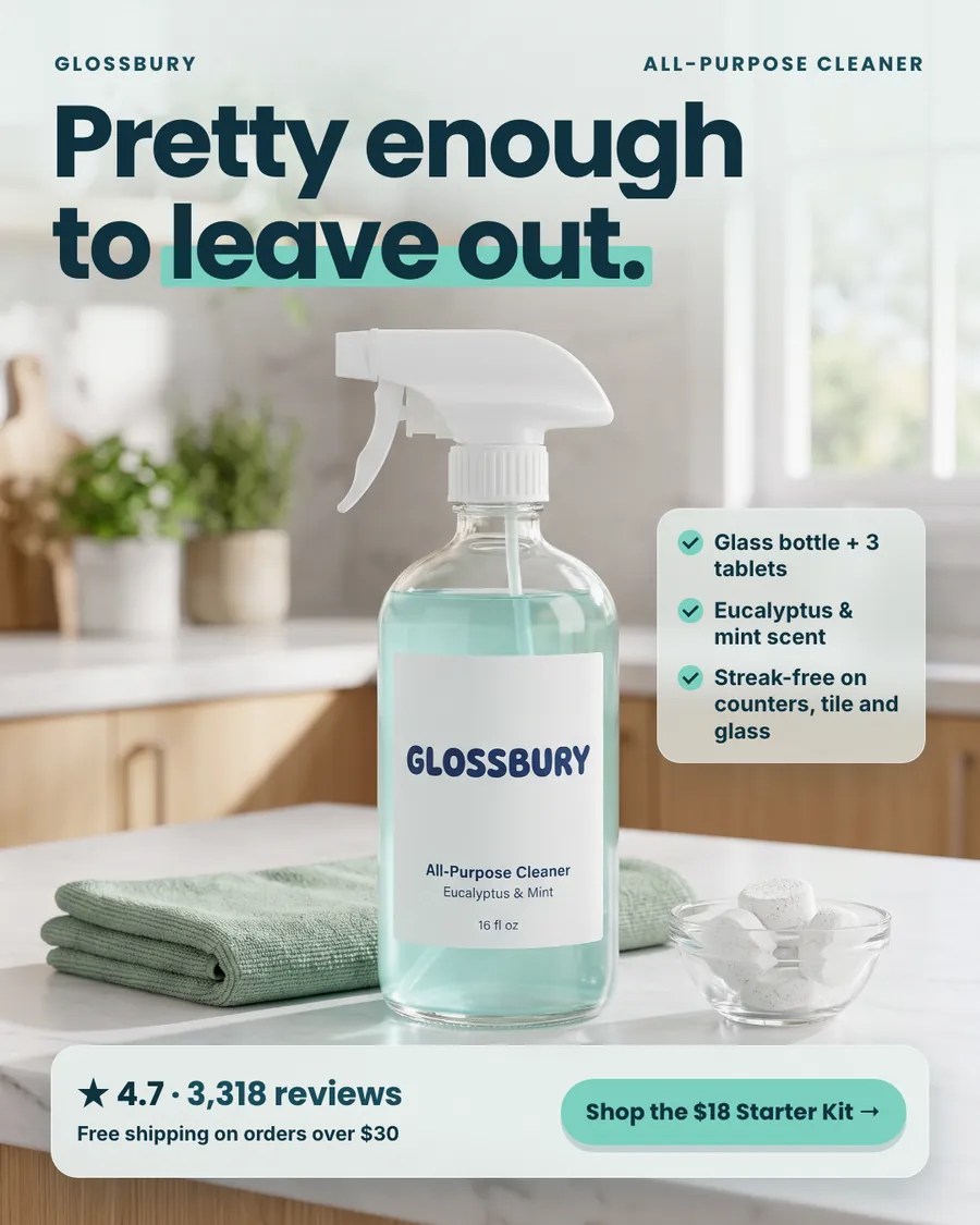 Light, airy kitchen photo Glossbury ad: 'Pretty enough to leave out.' A glass spray bottle labeled Glossbury All-Purpose Cleaner sits on a marble counter with a green cloth and a bowl of tablets. Three checkmarks, 4.7 from 3,318 reviews and a 'Shop the $18 Starter Kit' button.
