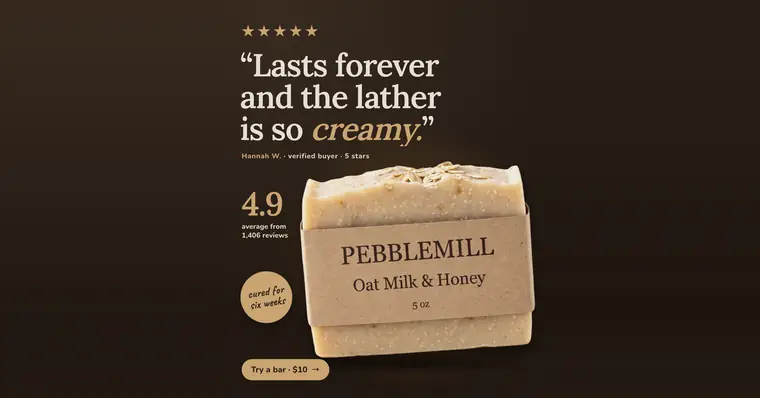 Dark brown Pebblemill Soap Co. ad: '“Lasts forever and the lather is so creamy.”' with five gold stars, a Hannah W. verified buyer credit, 4.9 average from 1,406 reviews, a 'cured for six weeks' badge, the oat soap bar in a kraft wrapper, and a 'Try a bar · $10' button. The 1.91:1 version.