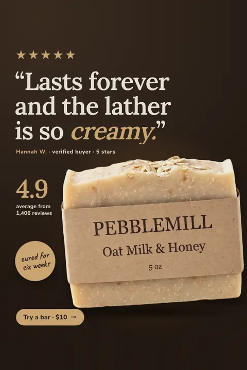 Dark brown Pebblemill Soap Co. ad: '“Lasts forever and the lather is so creamy.”' with five gold stars, a Hannah W. verified buyer credit, 4.9 average from 1,406 reviews, a 'cured for six weeks' badge, the oat soap bar in a kraft wrapper, and a 'Try a bar · $10' button. Shown here in the 2:3 Pinterest size.