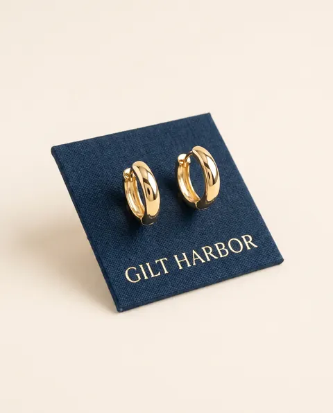 Gilt Harbor's product photo: Everyday Huggie Hoops, 18k Gold Vermeil, the packshot attached to prompts D and E.